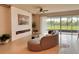 Bright living room boasts neutral tones, decorative fireplace and a serene view of the outdoors at 17319 Million Lakes Ct, Clermont, FL 34714