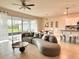 Modern living space with a spacious seating area and seamless transition to the outdoor patio at 17319 Million Lakes Ct, Clermont, FL 34714