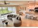 Open-concept living space with stylish furniture, pendant lighting, and seamless indoor-outdoor flow at 17319 Million Lakes Ct, Clermont, FL 34714