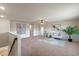 Upstairs loft area features neutral carpet, ample seating, and natural light from windows at 17319 Million Lakes Ct, Clermont, FL 34714