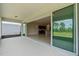Open patio featuring a smooth floor, sliding doors, and views of the backyard and interiors at 17319 Million Lakes Ct, Clermont, FL 34714