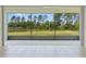 A screened-in patio offers serene views of a verdant backyard and distant trees at 17319 Million Lakes Ct, Clermont, FL 34714