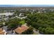 Aerial shot of townhouses near a lake and surrounded by trees, showcasing the natural beauty at 2011 Crestdale Ln, Lake Mary, FL 32746
