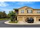 Exterior of townhomes with garage parking, well-kept lawns, and fresh landscaping at 2011 Crestdale Ln, Lake Mary, FL 32746