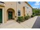 Charming front entryway with a green door, decorative wreath, and manicured shrubs at 2011 Crestdale Ln, Lake Mary, FL 32746