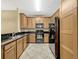 Kitchen featuring black appliances, granite countertops, and wood cabinets at 2011 Crestdale Ln, Lake Mary, FL 32746