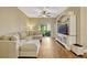 Comfortable living room with a large sectional couch, TV, and access to screened patio at 2011 Crestdale Ln, Lake Mary, FL 32746