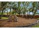 Community playground with climbing structures and mature trees offer shady recreation at 2011 Crestdale Ln, Lake Mary, FL 32746