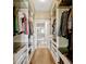 Organized walk-in closet featuring custom shelving, drawers, and rods for ample storage, leading to the bathroom at 2011 Crestdale Ln, Lake Mary, FL 32746