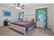 Cozy bedroom with a large bed and floral curtains at 203 N Sweetwater Blvd, Longwood, FL 32779