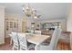 Bright dining area with stylish chandelier, white table, and a brick bar leading to the screened-in porch at 203 N Sweetwater Blvd, Longwood, FL 32779