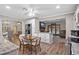 Open kitchen with white cabinetry, granite countertops, breakfast nook, and a view of the outdoor pool at 203 N Sweetwater Blvd, Longwood, FL 32779
