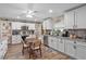 Updated kitchen features white cabinets, granite countertops, stainless steel appliances, and a breakfast nook at 203 N Sweetwater Blvd, Longwood, FL 32779