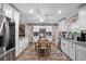Well-lit kitchen featuring white cabinets, stainless steel appliances, granite countertops, and an adjacent dining area at 203 N Sweetwater Blvd, Longwood, FL 32779