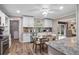 Bright kitchen with granite countertops, stainless steel appliances, and breakfast nook, all bathed in natural light at 203 N Sweetwater Blvd, Longwood, FL 32779