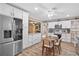 Bright kitchen boasts stainless steel appliances, white cabinetry, granite countertops, and adjacent breakfast nook at 203 N Sweetwater Blvd, Longwood, FL 32779