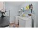 Functional laundry room includes a washer, dryer, shelving, and a utility sink at 203 N Sweetwater Blvd, Longwood, FL 32779