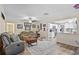 Comfortable living room featuring wood-look floors, neutral decor, and an open view into the kitchen at 203 N Sweetwater Blvd, Longwood, FL 32779