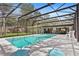 Enjoy a screened-in pool with an adjacent outdoor bar and eating area, perfect for entertaining under the sun at 203 N Sweetwater Blvd, Longwood, FL 32779