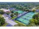 This aerial view shows multiple tennis courts in a community at 203 N Sweetwater Blvd, Longwood, FL 32779