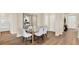 Elegant dining room with a glass table and modern chairs, wood-look floors and natural light at 2224 Albatross Nest Dr, Bartow, FL 33830