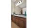 Bathroom vanity featuring granite countertop and dark wood cabinetry at 2319 Dammar St, Orlando, FL 32824