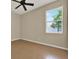 Well-lit bedroom features tile flooring and a ceiling fan at 2319 Dammar St, Orlando, FL 32824