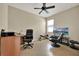 Bedroom featuring tile flooring and a ceiling fan; furnished with a desk and chairs at 2319 Dammar St, Orlando, FL 32824