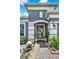 Elegant front entrance with decorative glass door, complemented by colorful potted plants and walkway at 2319 Dammar St, Orlando, FL 32824