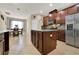 A well-appointed kitchen with dark cabinets, a center island, and stainless steel appliances, ideal for cooking and entertaining at 2319 Dammar St, Orlando, FL 32824