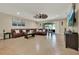 Large living room featuring a dark leather sectional, tile flooring, and plenty of natural light at 2319 Dammar St, Orlando, FL 32824