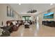 Bright and airy living room with neutral decor, tile floors, a large sectional sofa, and a TV at 2319 Dammar St, Orlando, FL 32824