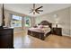 A serene primary bedroom featuring a decorative ceiling fan, offering a relaxing and stylish retreat at 2319 Dammar St, Orlando, FL 32824