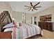 This primary bedroom offers a decorative ceiling fan and a dresser with TV, perfect for relaxation and entertainment at 2319 Dammar St, Orlando, FL 32824