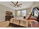 A cozy primary bedroom with a decorative ceiling fan, complemented by a dresser with a TV, ensuring a relaxing ambiance at 2319 Dammar St, Orlando, FL 32824