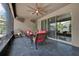 Enclosed patio featuring tile flooring, ceiling fan, and wicker furniture at 2319 Dammar St, Orlando, FL 32824