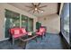 Enclosed patio featuring tile flooring, ceiling fan, and wicker furniture at 2319 Dammar St, Orlando, FL 32824