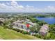 Aerial view showing complex near lake, lush greenery, parking, and common areas at 2550 N Alafaya Trl # 9201, Orlando, FL 32826