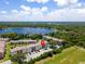 Aerial view of complex next to large lake with mature trees and lush landscaping at 2550 N Alafaya Trl # 9201, Orlando, FL 32826