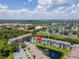 An aerial view of the complex, its parking, amenities, a pond, and lush landscaping at 2550 N Alafaya Trl # 9201, Orlando, FL 32826