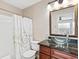 Features a glass bowl sink on a granite countertop and a bathtub with a decorative shower curtain at 2550 N Alafaya Trl # 9201, Orlando, FL 32826