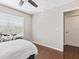 Bedroom featuring a window with blinds, an entry door, and neutral color palette at 2550 N Alafaya Trl # 9201, Orlando, FL 32826