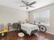Bedroom featuring a ceiling fan, dark wood floors, a window with blinds, and a neutral color palette at 2550 N Alafaya Trl # 9201, Orlando, FL 32826