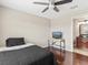 Features hardwood floors, a ceiling fan, and a view of the bathroom, with neutral wall paint at 2550 N Alafaya Trl # 9201, Orlando, FL 32826