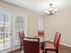 Dining area featuring a glass table, red chairs, and a chandelier at 2550 N Alafaya Trl # 9201, Orlando, FL 32826
