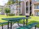 Apartment complex featuring well-maintained grounds with a green picnic table for outdoor enjoyment at 2550 N Alafaya Trl # 9201, Orlando, FL 32826