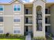 Close up showing building's balconies with black railings and light-colored siding at 2550 N Alafaya Trl # 9201, Orlando, FL 32826