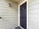 Close-up of the black front door with house number 5201 and an outdoor light fixture at 2550 N Alafaya Trl # 9201, Orlando, FL 32826
