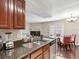 Features a sink, black granite countertop, and dining area with hardwood floors and natural lighting at 2550 N Alafaya Trl # 9201, Orlando, FL 32826