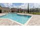 Community swimming pool with lounge chairs and nearby apartment buildings at 2550 N Alafaya Trl # 9201, Orlando, FL 32826